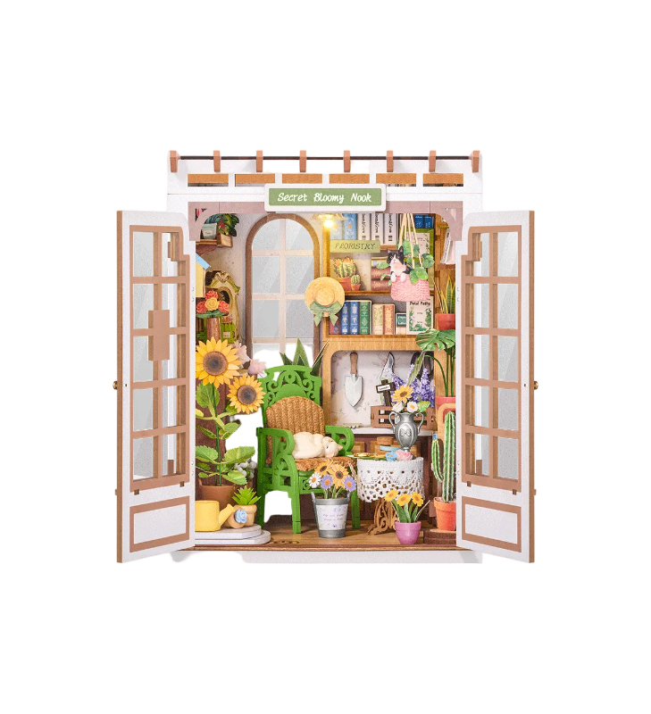 Miniature model of a cozy room with open doors, decorated with plants and furniture.