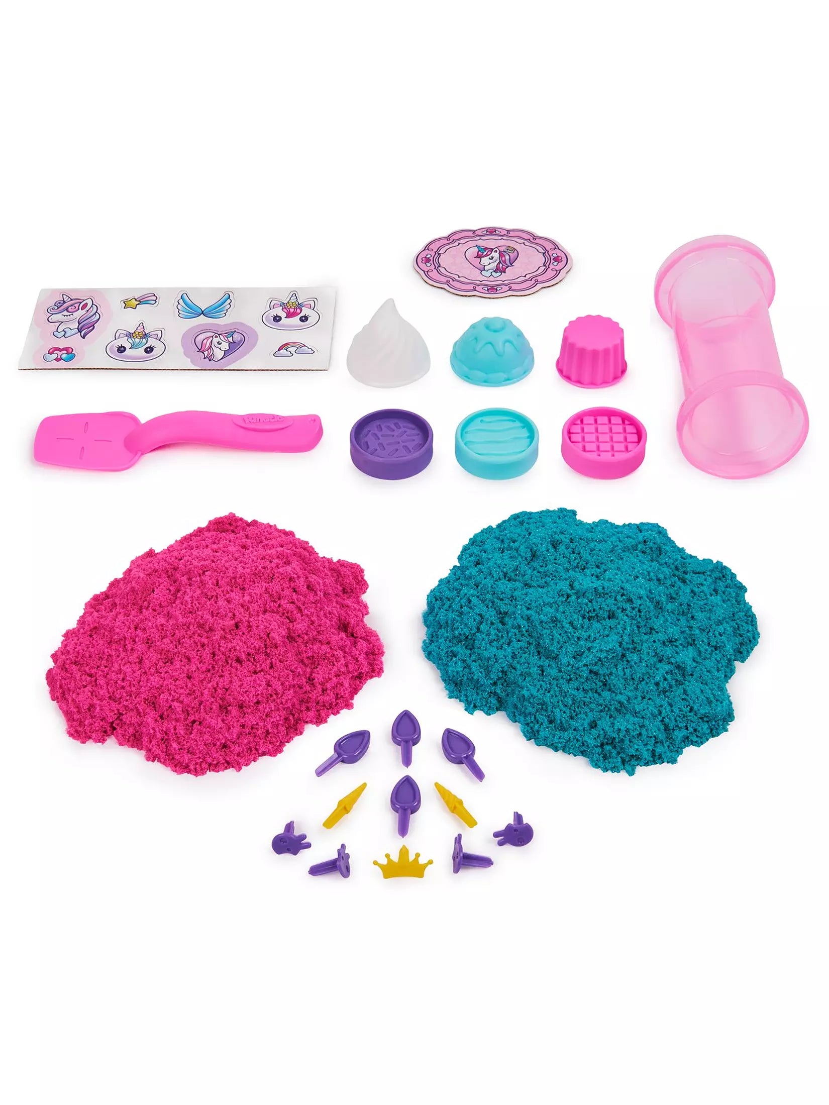 Colorful sand playset with pink and blue sand, tools, and decorative items on a white background